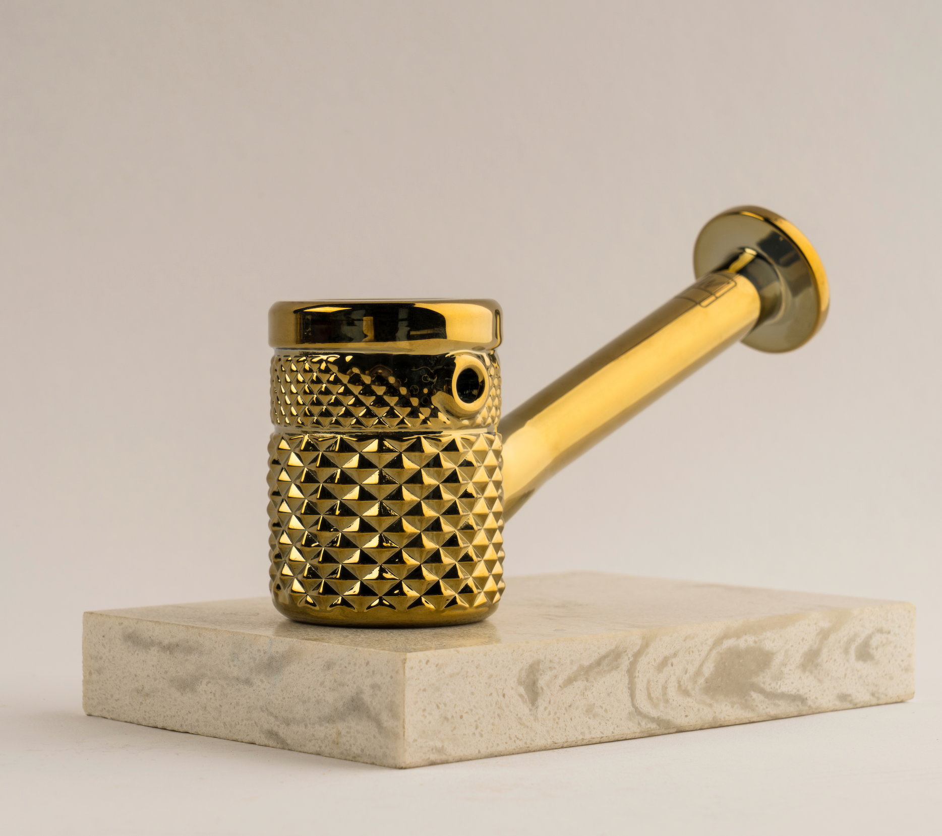 Gold Jane West Twenties Collection hand pipe, accessory with intricate design, made for stylish use.