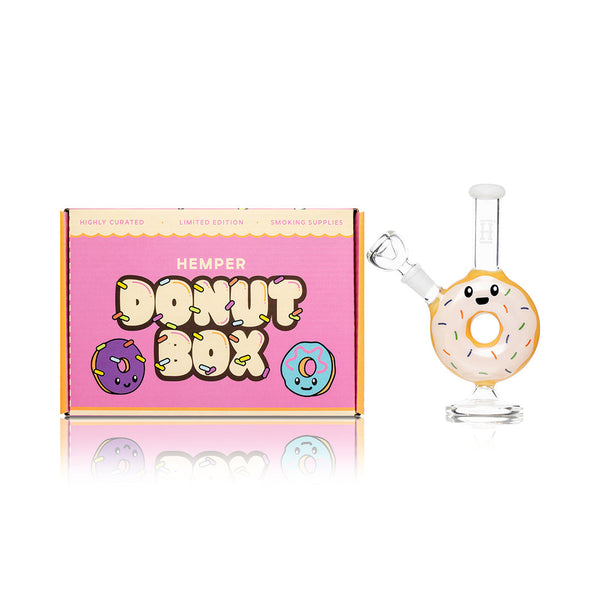 Hemper donut bong with colorful donut-shaped design and glass body, displayed with its packaging.