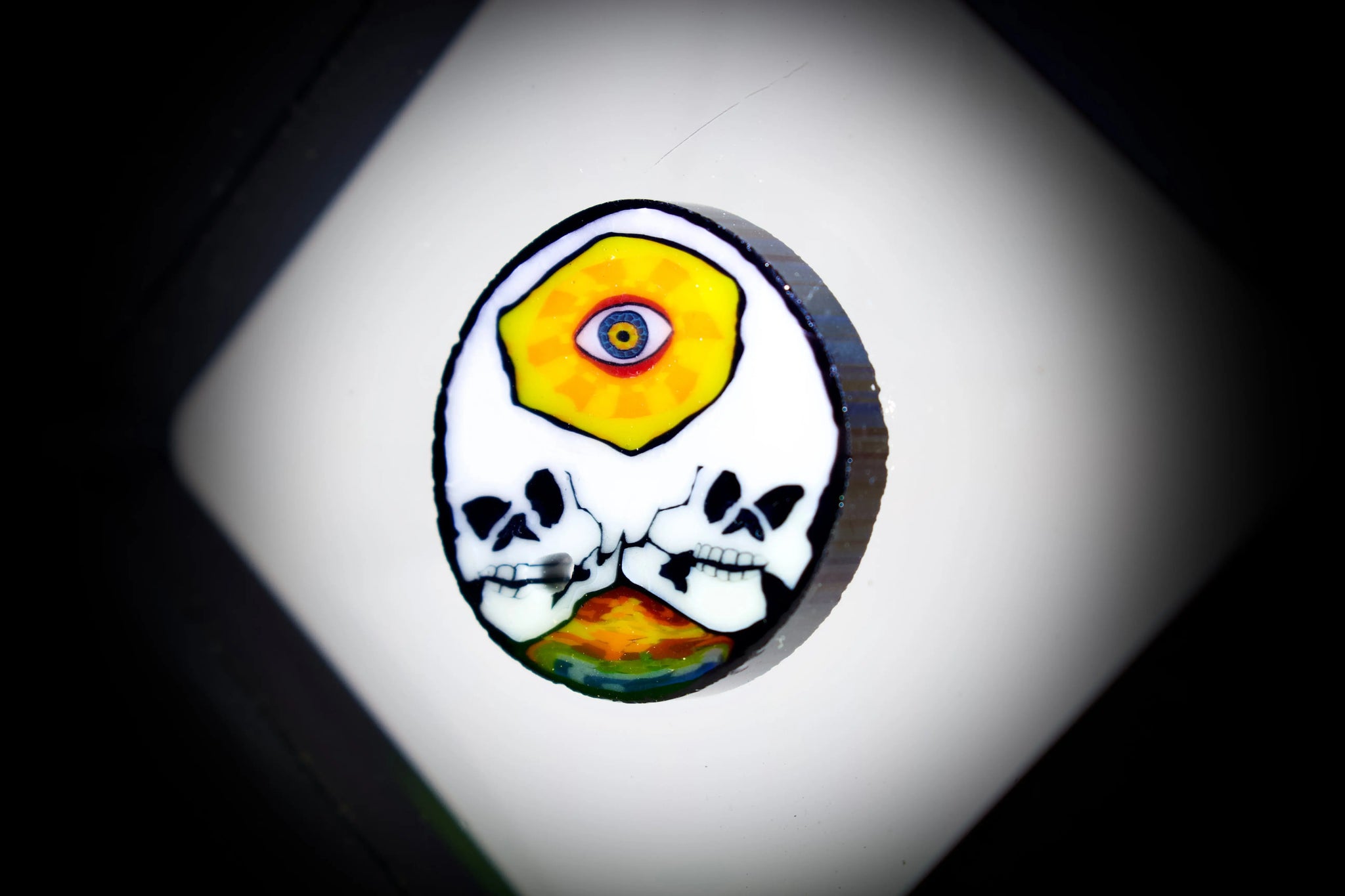 East Atlanta S&V AKM Glass Third Eye Skull Millie pipe maker tool, detailed skull design in vibrant colors.