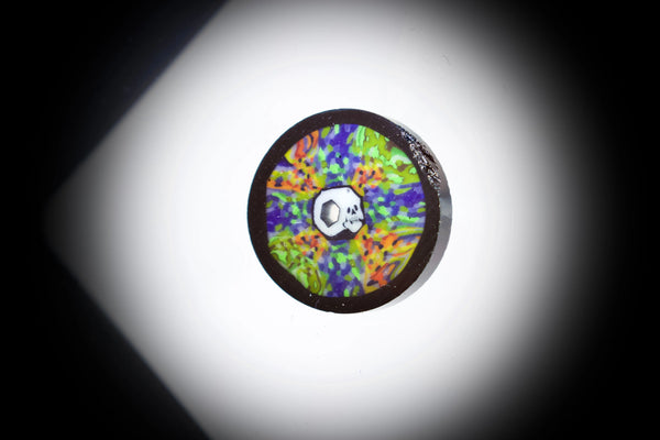 AKM Glass pipe by East Atlanta S&V featuring tie-dye honeycomb design with skull and brain motifs.