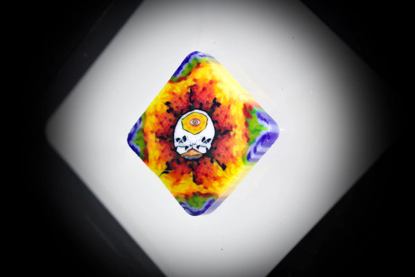 East Atlanta S&V AKM Glass Pipe Maker with tie-dye skull design, featuring colorful glass art and intricate detailing.