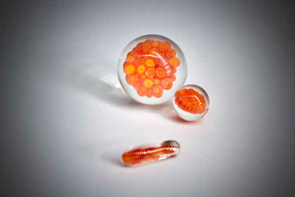 East Atlanta S&V Minguez Glass Millie Slurper Set with colorful glass pieces on a wooden surface