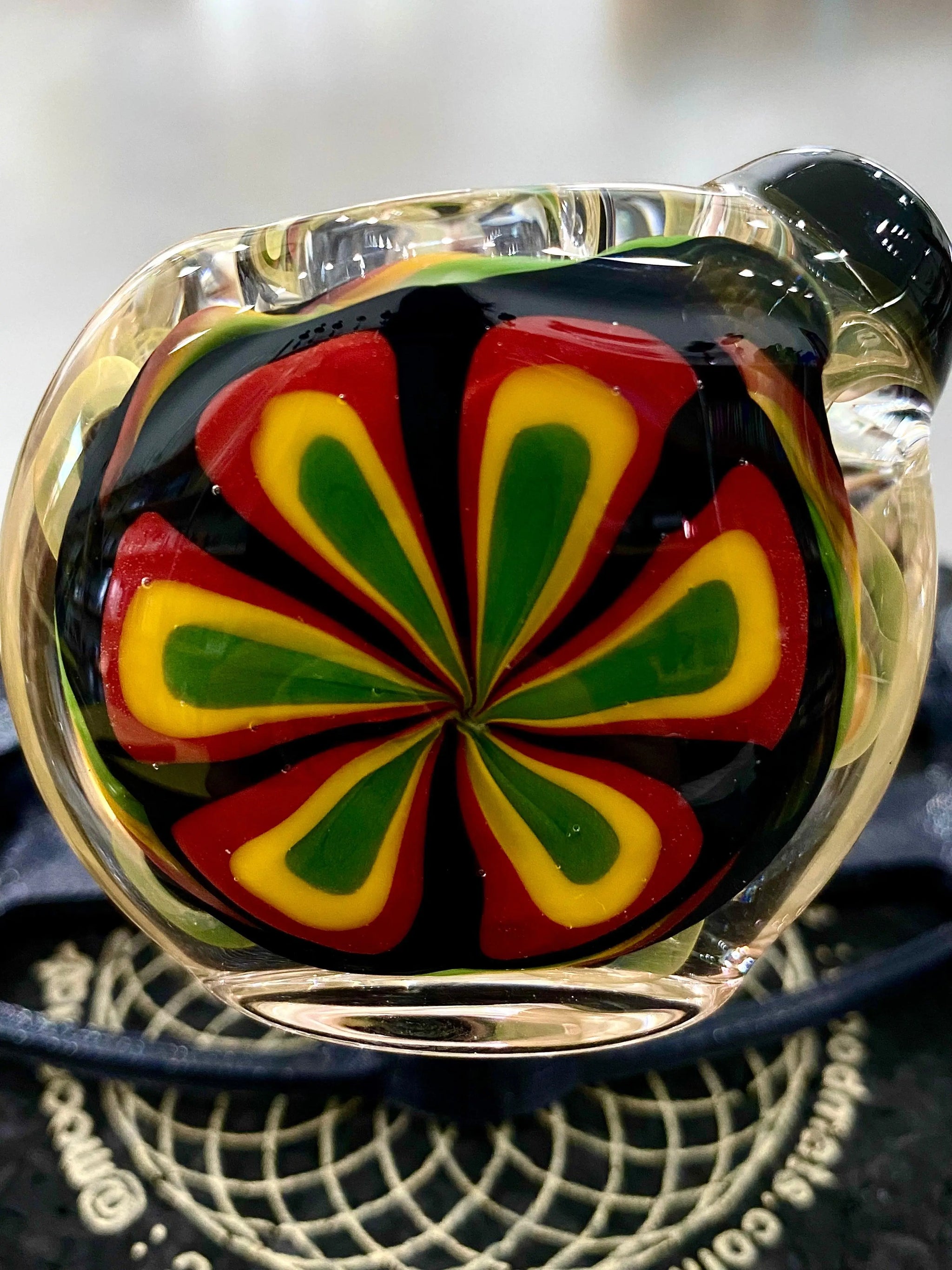 Color flower glass spoon pipe by Talent Glass Works Inc featuring vibrant floral designs and a smooth glass finish.